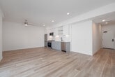 Located at 1450 Cloverfield Blvd in Santa Monica, California, this single-floor residence offers a clean, modern aesthetic throughout. Light wood-tone flooring flows seamlessly across the main living areas, creating a warm and cohesive feel. The open living area is bathed in natural light, enhanced by a ceiling fan and large sliding glass doors that open onto a private balcony with a glass railing — ideal for enjoying the Southern California climate.

The kitchen is well-appointed with stainless steel appliances, including a gas range, built-in microwave, refrigerator, and dishwasher. White flat-panel cabinetry extends to the ceiling, complemented by a white subway tile backsplash and open shelving, creating a bright and functional workspace.

The bathrooms are finished with striking large-format hexagonal floor tiles in a warm gray tone, white vanities with undermount sinks, matte black fixtures, and white subway tile shower surrounds. A spacious vanity mirror adds depth and brightness to the space.

Additional highlights include an in-unit stacked washer and dryer, multiple well-proportioned bedrooms with ample natural light, and clean white walls throughout that contribute to the residence's airy, contemporary ambiance. The thoughtful layout and modern finishes make this Santa Monica home a compelling and functional living space.