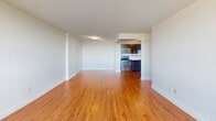 Located at 59 Concession St in Cambridge, Ontario, this well-appointed 2-bedroom, 1-bathroom unit is thoughtfully laid out across a single floor. Warm hardwood flooring flows throughout the space, lending a cohesive and inviting feel to every room.

The open-concept living area connects seamlessly to the kitchen, which is equipped with stainless steel appliances, including a range, microwave, and dishwasher. Rich dark-wood cabinetry with modern hardware complements the clean white countertops, providing ample storage and prep space.

Large floor-to-ceiling and wide-panel windows in the living area and bedrooms flood the space with abundant natural light and frame impressive panoramic views of Cambridge's skyline and lush tree canopy. The primary bedroom offers a generous footprint with a sliding closet and access to the same sweeping outdoor views.

The second bedroom is similarly bright, featuring hardwood flooring and large windows. The bathroom is finished with a white undermount sink set in a clean countertop, a full-width mirror with overhead lighting, and a dark wood vanity that echoes the kitchen cabinetry.

Overall, the unit presents a clean, modern aesthetic with functional design elements suited for comfortable everyday living.