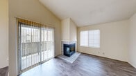 Located at 637 Stonebridge Way in Pleasant Hill, CA, this 2-bedroom, 2-bathroom single-level home offers a well-organized layout across a comfortable footprint. The living room is a standout space, featuring dramatic vaulted ceilings that amplify the sense of openness, a tile-surround corner fireplace with a glass front, and wood-look flooring. Sliding glass doors lead directly to a private balcony, flooding the room with natural light and providing outdoor access. Adjacent to the living room, the dining area benefits from the same bright, airy atmosphere. The kitchen features white cabinetry, dark countertops, white appliances including a range, microwave, and refrigerator, and a pass-through counter that connects it to the dining and living areas. Both bedrooms are carpeted and well-proportioned, with the primary bedroom offering generous closet space. The bathrooms are functional and clean, each featuring wood-look tile flooring, a tub/shower combination, and a vanity with dark stone-look countertops. Additional conveniences include in-unit laundry, a utility room, a hallway connecting the private spaces, and multiple closets throughout. The neutral color palette and consistent finishes create a cohesive and move-in ready environment.