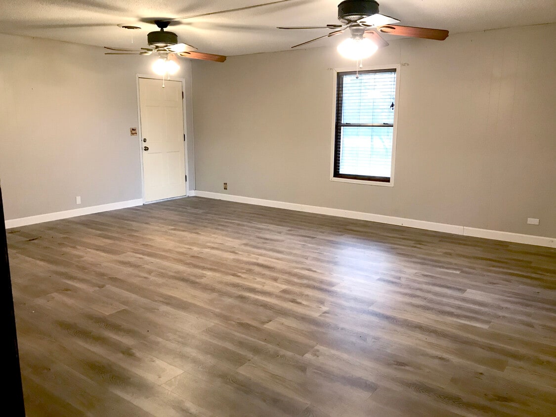 Large living room with luxury waterproof wood look vinyl flooring - 703 Lee St