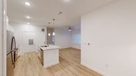 Located in Houston's 77070 corridor, this single-story, 2-bedroom, 3-bathroom home offers a clean, modern aesthetic throughout. The open-concept living and kitchen area serves as the heart of the home, anchored by a central island with a granite countertop, undermount sink, and stylish pendant lighting overhead. White shaker cabinetry, a subway tile backsplash, stainless steel appliances, and light hardwood-style flooring complete the kitchen's contemporary look. The adjoining living area provides generous space with a ceiling fan and a window that brings in natural light.

Both bedrooms continue the home's bright, neutral palette, each featuring light hardwood-style flooring, ceiling fans, and windows fitted with blinds for privacy and light control. The primary bedroom is a comfortable size and connects to a well-finished en-suite bathroom with a dual-sink granite vanity and modern brushed nickel fixtures. A spacious walk-in closet with built-in wire shelving offers ample storage. The additional bathrooms mirror the same refined finishes, maintaining consistency throughout the home.

A dedicated laundry area with an included washer adds everyday convenience. The overall design emphasizes clean lines, neutral tones, and functional layouts, making this home a practical and polished living space.