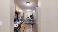 Located at 1025 Second St NE in Hopkins, MN, this one-bedroom, one-bathroom unit delivers a well-organized, single-floor layout designed to maximize every square foot. The galley-style kitchen features light maple cabinetry, dark granite countertops, a double stainless steel sink, and stainless steel appliances including a range, microwave, and dishwasher, all set above durable wood-look flooring. Adjacent to the kitchen is a dining nook with space for a bistro-style table, ideal for casual meals. The living room offers a bright, open feel with large windows dressed in vertical blinds that allow ample natural light, complemented by warm neutral walls, wood-look flooring, and a textured ceiling. The bedroom features plush carpeting, a generous sliding-door closet, a wall-mounted A/C unit, and a window with outdoor views, creating a comfortable and private retreat. The full bathroom includes a tub/shower combination, a white vanity with storage, and tile flooring. Throughout the unit, a cohesive neutral palette and consistent finishes create a calm, functional living environment suited for everyday comfort.