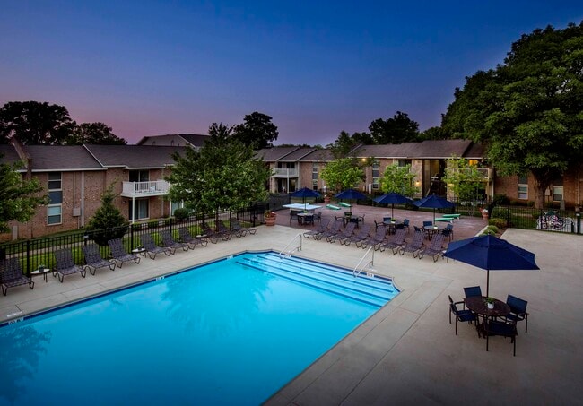 Resort-style pool at dusk - Plainview Apartments