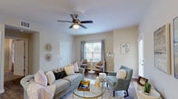 This single-story residence offers a thoughtfully designed layout across two bedrooms and two full bathrooms. The living area serves as the heart of the home, featuring warm wood-look flooring, neutral-toned walls, and a ceiling fan overhead. Natural light filters in through windows dressed with blinds and sheer curtains, creating a bright and inviting atmosphere. A glass door provides additional light and outdoor access.

The kitchen is well-equipped with white shaker-style cabinetry, granite-look countertops, and black appliances, including a range, microwave, and refrigerator. A peninsula with an undermount sink doubles as a breakfast bar, seamlessly connecting the kitchen to the living space. Pendant lighting and wood-look flooring complete the functional yet stylish design.

Both bedrooms are carpeted and feature ceiling fans and windows that allow natural light. Each room offers a comfortable, quiet retreat. The two bathrooms mirror each other in style, featuring white cabinetry, granite-look countertops, undermount sinks, and wood-look flooring. One bathroom includes a full tub-shower combination. Throughout the residence, consistent finishes and a neutral color palette create a cohesive and modern ambiance.