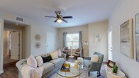 This single-story residence offers a thoughtfully designed layout across two bedrooms and two full bathrooms. The living area serves as the heart of the home, featuring warm wood-look flooring, neutral-toned walls, and a ceiling fan overhead. Natural light filters in through windows dressed with blinds and sheer curtains, creating a bright and inviting atmosphere. A glass door provides additional light and outdoor access.

The kitchen is well-equipped with white shaker-style cabinetry, granite-look countertops, and black appliances, including a range, microwave, and refrigerator. A peninsula with an undermount sink doubles as a breakfast bar, seamlessly connecting the kitchen to the living space. Pendant lighting and wood-look flooring complete the functional yet stylish design.

Both bedrooms are carpeted and feature ceiling fans and windows that allow natural light. Each room offers a comfortable, quiet retreat. The two bathrooms mirror each other in style, featuring white cabinetry, granite-look countertops, undermount sinks, and wood-look flooring. One bathroom includes a full tub-shower combination. Throughout the residence, consistent finishes and a neutral color palette create a cohesive and modern ambiance.