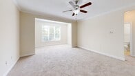 Located at 450 Seasons Pl NW in Concord, NC, this single-story, 3-bedroom, 2-bathroom home offers a thoughtfully arranged floor plan across a comfortable and cohesive living space. The living room is a standout feature, offering generous proportions, soft wall-to-wall carpeting, crown molding, a ceiling fan with light fixture, and a recessed window nook that frames natural light beautifully. The dining room is finished with tile flooring, chair rail molding, and an elegant chandelier overhead. The kitchen is well-equipped with warm wood cabinetry, granite countertops, tile flooring, and black appliances including a refrigerator, range, and over-the-range microwave. The spacious primary bedroom includes plush carpeting, a ceiling fan, crown molding, and access to a walk-in closet with wire shelving. The additional bedrooms are bright and carpeted, each with natural light from well-positioned windows. The bathrooms feature tile flooring, rich wood vanities with granite countertops, and a tub-shower combination. A dedicated laundry area includes washer and dryer hookups and built-in wire shelving for added utility. Three closets throughout the home provide ample storage, completing this well-designed residence.