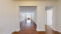 Located at 841 Highland Ave in Jenkintown, PA, this one-bedroom, one-bathroom residence offers a thoughtfully laid-out single-floor plan. Rich, warm hardwood floors flow throughout the main living areas and bedroom, lending a classic character to the space. The living room is generously proportioned, framed by large windows fitted with blinds that invite abundant natural light. A decorative archway connects the hallway to the living area, adding an architectural detail that enhances the sense of openness and flow. The bedroom is a comfortable, well-sized retreat featuring dual windows, a ceiling fan, and a classic cast-iron radiator, combining vintage charm with practical comfort. The kitchen is equipped with white cabinetry, granite-style countertops, a white dishwasher, subway tile backsplash, and light tile flooring, with a window providing natural light for a pleasant cooking environment. The bathroom showcases timeless design with white subway wall tiles, a classic clawfoot-style soaking tub, chrome fixtures, a mosaic tile floor, and a framed mirror, offering a clean and cohesive aesthetic. Neutral cream-toned walls throughout the residence create a calm, versatile backdrop, making this Jenkintown residence a well-preserved and inviting home.