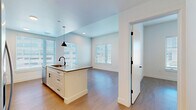 Located at 3740 N Downing St in Denver's vibrant Cole neighborhood, this single-floor, 2-bedroom, 3-bathroom home offers a clean, modern design with thoughtful finishes throughout. Light wood flooring flows seamlessly across every room, lending warmth and continuity to the space.

The kitchen is a standout feature, equipped with stainless steel appliances, white shaker cabinetry, a decorative blue tile backsplash, and a central island with a built-in sink and dark countertops. Pendant lighting accents the island, while multiple windows flood the area with natural light. The adjacent living area provides an open, airy layout ideal for entertaining.

Both bedrooms are well-proportioned and bright, each benefiting from large windows with blinds. The primary bedroom offers a generous footprint and dedicated closet access. A second bedroom features a distinctive teal accent wall paired with dual windows, creating an inviting atmosphere. A third, cozier room with a single window offers flexibility as a bedroom or office.

Three bathrooms serve the home, including one with a white vanity, arched mirror, matte black fixtures, and open shelving, and another featuring a soaking tub with a curved rod. Hallways are clean and well-lit with recessed lighting, and two closets provide ample storage throughout this efficiently designed home.