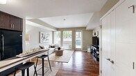 Located at 2895 Pauling Ave in Richland, WA, this thoughtfully designed one-bedroom, two-bathroom residence offers a efficient and comfortable single-floor layout. Warm hardwood-style flooring flows throughout the main living areas, creating a cohesive and inviting atmosphere.

The open kitchen is a functional highlight, featuring a two-tone cabinet design with rich dark lower cabinets and crisp white uppers, granite-style countertops, under-cabinet lighting, stainless steel appliances, and a convenient breakfast bar with seating — ideal for casual dining.

The living room is bright and airy, anchored by large floor-to-ceiling windows that frame lush outdoor greenery and fill the space with natural light. Neutral warm-toned walls complement the overall modern aesthetic.

The bedroom is a calm retreat with plush carpeting, a generous window allowing natural light, and direct access to a closet. Two bathrooms serve the unit — one featuring a soaking tub and sliding closet doors with in-unit laundry access, and the other offering hardwood-style flooring and dark cabinetry with granite countertops.

The overall ambiance is clean, modern, and functional, making this residence a well-balanced urban living space in the heart of Richland.