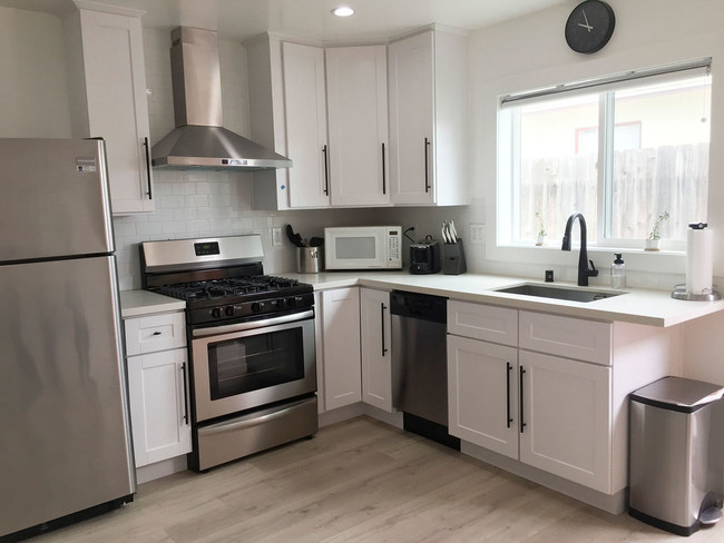 Full Kitchen w/stainless steel appliances - 8399 Belford Ave