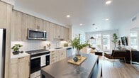 Located at 37 8th Ave in Oakland, CA, this thoughtfully designed 2-bedroom, 2-bathroom residence offers a well-organized single-level layout with modern finishes throughout. Light wood-style flooring flows seamlessly across the entire space, creating a cohesive and airy feel.

The open-concept kitchen is a standout feature, outfitted with light wood cabinetry extending to the ceiling, a white tile backsplash, white quartz countertops, stainless steel appliances including a gas range, built-in microwave, dishwasher, and side-by-side refrigerator, plus a dark-topped kitchen island that doubles as a dining and prep area.

The kitchen opens directly into the living room, which is bathed in natural light from large floor-to-ceiling sliding glass doors leading to a private balcony with outdoor seating. The bright, open living area offers a comfortable and versatile space for both relaxing and entertaining.

The spacious primary bedroom features a large picture window with exterior views and connects to a well-appointed bathroom with a wood-toned vanity, illuminated mirror, and light wood flooring. A generously sized walk-in closet with multi-level shelving and hanging rods provides ample storage. The second bedroom is equally bright and well-proportioned, served by a second full bathroom. A hallway and two closets complete this well-planned home.