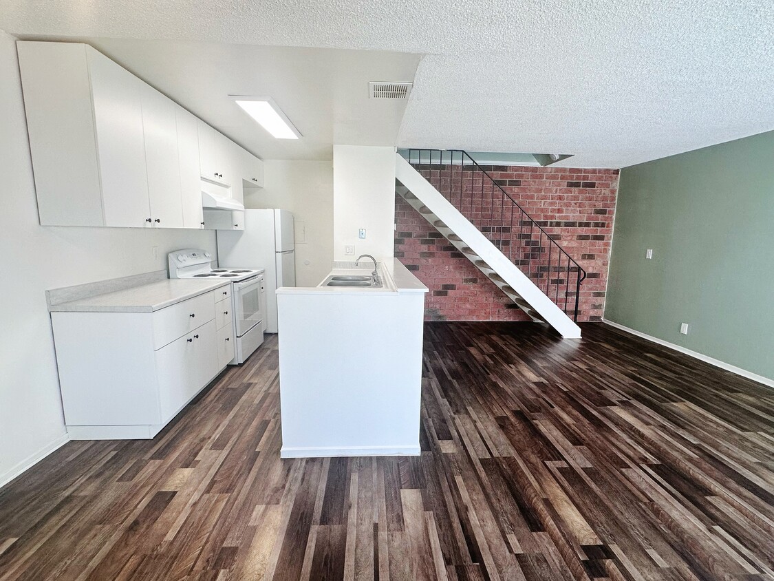 Viewing from dining area toward kitchen area and the stairs to beds and bath upstairs - 5494 Judith St