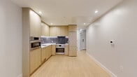 Located in the heart of Washington, DC, this thoughtfully designed two-bedroom, two-bathroom residence offers a clean, contemporary aesthetic with high-quality finishes throughout. Light-toned hardwood flooring flows seamlessly across the entire single-level layout, creating a cohesive and airy feel.

The open kitchen is a standout feature, showcasing flat-front light wood cabinetry extending to the ceiling for ample storage, a dark slate-toned tile backsplash, white quartz countertops, and a full suite of stainless steel Bosch appliances, including a gas range, wall oven, built-in microwave, and integrated refrigerator. The kitchen opens directly into the living area, ideal for everyday living and entertaining.

Both bathrooms are finished to a high standard, featuring large-format marble-look floor tiles, floating light wood vanities with white countertops, and tub-shower combinations accented by textured grey wall tile. Recessed lighting enhances the clean, modern atmosphere.

The bedrooms are bright and well-proportioned, with the primary bedroom offering generous space. Floor-to-ceiling sliding glass doors in the bedrooms invite natural light and provide views of the surrounding greenery. A dedicated closet with built-in shelving and racking offers practical storage. Recessed lighting throughout completes this polished, move-in ready residence.