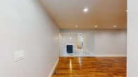 This well-appointed single-floor home in Ewing Township, NJ, offers three bedrooms, two bathrooms, and a thoughtfully designed layout. The open living area features gleaming hardwood floors and recessed lighting, flowing seamlessly into the updated kitchen. The kitchen is outfitted with dark shaker-style cabinetry, white quartz countertops, a marble-style tile backsplash, and a full suite of stainless steel appliances, including a gas range, built-in microwave, and refrigerator. A central island adds additional workspace and visual appeal. The three bedrooms each feature warm hardwood flooring and modern multi-arm light fixtures. Two of the bedrooms offer windows with views of surrounding greenery, filling the rooms with natural light. The primary bedroom is generously sized, providing ample living space. One bedroom features lighter-toned hardwood flooring for a subtle contrast. The two bathrooms are finished with large-format marble-style tile, offering a clean and contemporary aesthetic. The full bath includes a soaking tub and a window for natural ventilation. Two closets provide convenient storage throughout the home. The overall ambiance is bright, modern, and move-in ready.