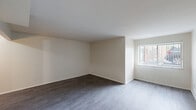 Located at 1045 E Woodward Heights Blvd in Hazel Park, MI, this one-bedroom, one-bathroom unit offers a well-organized, single-floor layout designed for efficient everyday living. The combined living and dining area is an open, light-filled space featuring dark, wood-look luxury vinyl plank flooring and neutral white walls that create a clean, versatile backdrop. A large window allows natural light to flood the room, enhancing the sense of openness. The kitchen is appointed with rich, dark wood cabinetry, light stone-look countertops, a subway tile backsplash, and a stainless steel range with a ventilation hood — providing both style and functionality. A hallway connects the main living areas to the private quarters, lined with multiple closets for ample storage. The bedroom is a comfortable, carpeted retreat featuring its own dedicated walk-in closet, offering generous storage space. The full bathroom includes a tiled shower-tub combination with chrome fixtures, maintaining a clean and classic aesthetic. With three total closets throughout, practical storage is a key feature of this thoughtfully laid-out unit.