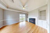 Located at 25 Great Pond Rd in Leominster, MA, this well-appointed single-floor home offers 2 bedrooms, 2 bathrooms, and a thoughtfully designed layout. The open living area is a standout, showcasing warm hardwood flooring, a tray ceiling with a ceiling fan, a granite-surround gas fireplace flanked by built-in cabinetry, and sliding glass doors that flood the space with natural light and provide views of the surrounding greenery. The combined dining and kitchen area flows seamlessly from the living room, complementing the home's open feel. Both bedrooms feature plush carpeting, ceiling fans, and windows offering outdoor views. The primary bedroom is generously sized, offering comfortable living quarters. The two bathrooms are finished with tile flooring, rich wood cabinetry, dark granite countertops, and undermount sinks. The primary bath includes accessibility features such as grab bars. Additional highlights include six closets providing ample storage, an in-unit laundry room, and an attached garage. The neutral color palette and clean finishes throughout create a bright, cohesive ambiance suited for comfortable everyday living.