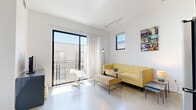 Located at 3425 Motor Ave in Los Angeles, CA, this modern one-bedroom, one-bathroom unit offers a thoughtfully designed open-concept layout across a single floor. Polished concrete floors run throughout, lending a sleek, industrial aesthetic that ties each space together cohesively.

The living room is bright and airy, anchored by a large sliding glass door that opens to a private balcony, inviting an abundance of natural light and outdoor views. A secondary window further enhances the sense of openness. Track lighting overhead provides flexible illumination for the space.

The kitchen is efficiently designed and flows directly from the living area. It features two-tone cabinetry — white uppers paired with dark wood lowers — complemented by a white subway tile backsplash, stainless steel appliances including a gas range, microwave, and refrigerator, and a single-basin sink. A distinctive plywood entry door adds a warm, natural contrast to the contemporary palette.

The bedroom is a calm, well-proportioned retreat with a large window that brings in ample daylight and neighborhood views. Clean white walls and concrete flooring continue the consistent design language of the unit.

The bathroom maintains the modern aesthetic with a glass-enclosed walk-in shower featuring white tile, a dark wood vanity with a light countertop, and polished concrete flooring that echoes the rest of the home.