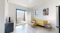 Located at 3425 Motor Ave in Los Angeles, CA, this modern one-bedroom, one-bathroom unit offers a thoughtfully designed open-concept layout across a single floor. Polished concrete floors run throughout, lending a sleek, industrial aesthetic that ties each space together cohesively.

The living room is bright and airy, anchored by a large sliding glass door that opens to a private balcony, inviting an abundance of natural light and outdoor views. A secondary window further enhances the sense of openness. Track lighting overhead provides flexible illumination for the space.

The kitchen is efficiently designed and flows directly from the living area. It features two-tone cabinetry — white uppers paired with dark wood lowers — complemented by a white subway tile backsplash, stainless steel appliances including a gas range, microwave, and refrigerator, and a single-basin sink. A distinctive plywood entry door adds a warm, natural contrast to the contemporary palette.

The bedroom is a calm, well-proportioned retreat with a large window that brings in ample daylight and neighborhood views. Clean white walls and concrete flooring continue the consistent design language of the unit.

The bathroom maintains the modern aesthetic with a glass-enclosed walk-in shower featuring white tile, a dark wood vanity with a light countertop, and polished concrete flooring that echoes the rest of the home.