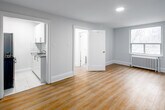 Located at 262 Jarvis St, Suite 608 in downtown Toronto, this one-bedroom, one-bathroom unit offers a practical and well-appointed layout across a single floor. The spacious bedroom is the heart of the unit, featuring warm hardwood-style flooring, clean white walls, and a window with city views that allows natural light to fill the room. A classic radiator provides in-unit heating, adding a touch of traditional character. Recessed ceiling lighting throughout lends a clean, modern finish.

The bathroom is bright and fully tiled in white, featuring a soaker tub and shower combo with a curved curtain rod, a toilet, and a radiator for warmth. A small window provides natural ventilation and additional light, keeping the space feeling fresh and open.

The kitchen is compact and efficiently designed, equipped with a stainless steel gas range and a full-size refrigerator, set against white walls and light tile flooring. The unit also includes a dedicated closet for storage. Clean lines, neutral tones, and updated finishes throughout give the space a move-in-ready feel, making it a functional and comfortable option in the heart of Toronto's downtown core.
