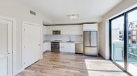 This well-appointed one-bedroom, one-bathroom unit is located at 500 N Andrews Avenue in the heart of Fort Lauderdale, Florida. The thoughtfully designed layout makes efficient use of its compact footprint, offering a clean, modern aesthetic throughout.

The open-concept kitchen is a standout feature, showcasing floor-to-ceiling white flat-panel cabinetry, a marble-style tile backsplash, and a full suite of stainless steel appliances including a French door refrigerator, electric range, built-in microwave, and dishwasher. A neutral gray countertop and an undermount sink complete the functional workspace, with natural light streaming in from an adjacent balcony access point.

Wood-look plank flooring runs throughout the main living areas and bedroom, lending warmth and continuity to the space. The bedroom is a well-proportioned room with clean white walls, a dedicated closet, and direct access to the bathroom.

The bathroom is finished with a marble-style tiled tub and shower surround, a sleek backlit vanity mirror, a white quartz countertop with a wood-toned vanity base, and tile flooring — creating a bright, spa-like atmosphere.

A dedicated closet provides additional storage, and the overall neutral color palette of whites and warm beiges gives the unit a fresh, move-in-ready feel suited for comfortable urban living in Fort Lauderdale.