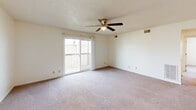 Located at 2805 W Larchmont Ln in Peoria, Illinois, this single-floor, 3-bedroom, 1-bathroom home offers a functional and straightforward layout. The living area is generously sized, featuring soft carpeting, a ceiling fan with light fixture, and a sliding glass door that opens to a private balcony, allowing natural light to fill the space. The galley-style kitchen is well-equipped with white cabinetry, dark countertops, wood-look flooring, a double-basin sink, and stainless steel appliances including a refrigerator, electric range, dishwasher, and built-in microwave. The spacious primary bedroom features plush carpeting and direct access to the bathroom through a private door. The additional two bedrooms are carpeted and each include windows that bring in natural light, providing comfortable and versatile spaces. The full bathroom features wood-look flooring, a wide vanity with a single sink, a large mirror, a bathtub, and a toilet, all finished in a clean, neutral palette. Throughout the home, textured ceilings, white panel doors, and neutral walls create a cohesive and clean aesthetic. A closet and hallway complete the practical layout of this well-organized home.