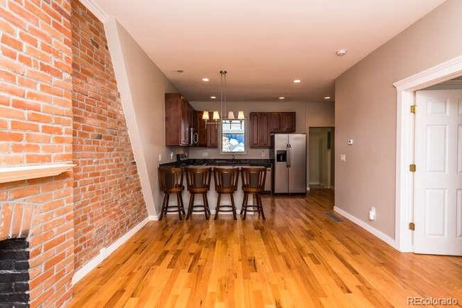 Real hardwood floors and exposed brick throughout. - 1231 31st St