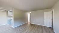 Located at 200 Seneca St in Merced, California, this single-story 2-bedroom, 1-bathroom home offers a clean, functional layout with modern updates throughout. The interior features a consistent neutral color palette, white baseboards, and textured ceilings that lend a classic residential feel.

The spacious primary bedroom is finished with light-toned luxury vinyl plank flooring, neutral gray walls, and a built-in wall vent for climate control. It includes a dedicated closet and connects conveniently to the hallway. The second bedroom features plush carpet flooring and receives generous natural light, with its own closet for storage.

The kitchen is well-equipped with gray-toned cabinetry, light laminate countertops, recessed lighting, and a stainless steel sink. White appliances including a range and refrigerator are included. LVP flooring extends through this space, maintaining a cohesive look.

The bathroom features a full tub-shower combo with white subway tile surround, a vanity with a single sink and storage below, and matching LVP flooring. A living area with carpet flooring connects the bedrooms and provides a transitional space with access to the kitchen and bath.

Throughout the home, consistent finishes, ample closet space, and a practical single-floor design make this a comfortable and move-in ready residence.