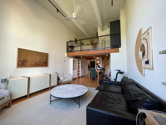 Large living room looking back into dining and loft. - 66 Bell St