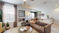 Located in Georgetown, TX, this multi-level 2-bedroom, 2-bathroom home offers a well-organized layout spread across three floors. The entry level provides a welcoming transition into the space, with light wood-style flooring and a secondary living area that offers a quiet retreat. Stairs lead to the main living floor, where an open-concept design seamlessly connects the kitchen, dining room, and living room. The kitchen features granite countertops, white cabinetry, stainless steel appliances, and a central island with a sink. The dining area is bathed in natural light from large windows with outdoor views, complemented by rich olive-toned walls and hardwood-style flooring. The living room is bright and airy, with a ceiling fan, multiple windows, and ample space for comfortable seating. The upper floor houses both bedrooms, each with plush carpet, natural light, and generous proportions. The primary bedroom provides a serene retreat. Both bathrooms are finished with granite-topped vanities, tub-shower combinations, and wood-style tile flooring, offering a clean and cohesive aesthetic throughout the home.