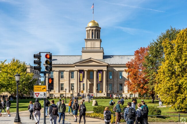 University of Iowa students walk in front of the Old Capitol Museum at the center of campus.