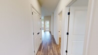 Located in Concord Crossing in Lafayette, Indiana, this single-story, 2-bedroom, 2-bathroom home offers a thoughtfully designed layout with modern finishes throughout. The open-concept kitchen and living area serves as the heart of the home, featuring wood-look hard-surface flooring, recessed lighting, and a central kitchen island with dark granite-style countertops and an undermount sink. White shaker-style cabinetry lines the kitchen walls, complemented by stainless steel appliances and pendant lighting that adds a contemporary touch. A pantry provides additional storage.

The living room extends naturally from the kitchen, bathed in natural light from a sliding glass door and flanking windows that offer outdoor views. A ceiling fan overhead adds comfort to the space.

Both bedrooms are carpeted for warmth and comfort, each featuring ceiling fans and windows that bring in natural light. The bathrooms include wood-look flooring, white cabinetry, dark countertops, and walk-in showers. A dedicated laundry room with full-size washer and dryer hookups adds practicality.

A central hallway with white paneled doors and black hardware connects the private areas of the home, tying together a clean, cohesive aesthetic throughout.
