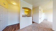 This single-floor residence offers a thoughtfully designed layout that balances functionality and comfort. The kitchen is a standout feature, showcasing white cabinetry, dark granite-style countertops, a double sink, and white appliances including a range and over-the-range microwave. It connects to the living area through a distinctive arched pass-through, enhancing the open flow of the space. Hardwood-style flooring runs through the kitchen and bathroom areas, while plush carpeting extends throughout the bedrooms and living spaces.

The bedrooms are generously sized, each featuring ceiling fans with light fixtures, crown molding, and large windows with blinds that allow ample natural light and outdoor views. The spacious rooms provide a bright and airy atmosphere well-suited for comfortable living.

The bathroom includes a tiled tub-shower combination, hardwood-style flooring, and a vanity, with a door that opens directly to the main living area. A large walk-in closet with wire shelving provides excellent storage capacity. Throughout the residence, crown molding and neutral warm tones contribute to a cohesive and inviting ambiance, making this a practical and comfortable living space.