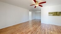 This contemporary 880 square foot apartment in Austin, Texas offers a well-designed living space with two bedrooms and two bathrooms. The single-story layout maximizes efficiency, with the primary bedroom boasting a generous 160 square feet. Throughout the apartment, warm hardwood floors create a cohesive and inviting atmosphere.

The open-concept design seamlessly integrates the kitchen, living, and dining areas, promoting a spacious feel. The kitchen features light gray cabinetry, white appliances, and ample counter space, ideal for meal preparation. Both bathrooms are modernly appointed with white fixtures, tiled showers, and vanities with storage.

Each bedroom is equipped with a ceiling fan and large windows, allowing for natural light and air circulation. The apartment includes closet space in both bedrooms and additional storage areas. A covered porch extends the living area outdoors, offering a pleasant spot to enjoy the surrounding neighborhood views.

The property's location at 2340 1/2 Cromwell Circle places residents in the heart of Austin's vibrant community. With its efficient use of space, modern amenities, and prime location, this apartment presents an attractive option for those seeking a comfortable urban dwelling.
