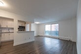 Located at 836 Talwood Dr in Peterborough, Ontario, this well-appointed 3-bedroom, 1-bathroom unit offers a comfortable and functional layout across a single floor. Light-toned hardwood-style flooring runs throughout, complementing the clean, white walls and creating a bright, cohesive aesthetic.

The kitchen has been tastefully updated with crisp white shaker cabinetry, a subway tile backsplash, dark countertops, and stainless steel appliances including a refrigerator, electric range, and built-in microwave. A pass-through opening connects the kitchen to the combined dining and living area, enhancing the open feel of the shared space. The living room benefits from large sliding glass doors that lead to a private balcony, allowing abundant natural light and outdoor views.

Three well-sized bedrooms each feature light-filled windows, baseboard heating, and wood-style flooring. The generously sized primary bedroom includes two dedicated closets with built-in shelving, offering excellent storage. Additional closets in the hallway further maximize organization.

The bathroom is finished with floor-to-ceiling tile surrounding a full soaker tub and shower combination, with classic chrome fixtures. The unit's clean, neutral palette and updated features make it a practical and inviting living space.