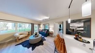 Located at 1835 SE 136th Street in North Bend, Washington, this thoughtfully designed single-floor residence offers a seamless blend of modern style and everyday comfort. The open-concept living area is anchored by light wood-tone flooring, track lighting, and generous windows that draw in natural light and frame views of lush greenery outdoors. The space comfortably accommodates both a lounging area and a dedicated workspace, making it highly functional.

The kitchen is outfitted with stainless steel appliances, including a full-size refrigerator and electric range, complemented by floor-to-ceiling cabinetry in a warm wood-grain finish, a glossy tile backsplash, and a large island with white quartz countertops and an undermount sink — ideal for cooking and entertaining.

The bedrooms offer plush carpeting, large windows overlooking the landscaped grounds, and access to walk-in closets. The primary bedroom connects to a private en-suite bathroom featuring a wide vanity with white countertops, wood-toned cabinetry, and light wood-style flooring. A second bathroom echoes this aesthetic with the addition of a bold deep-green accent wall, adding a distinctive design touch.

Throughout, the residence maintains a clean, contemporary palette with curated details that create a warm and inviting ambiance.