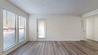 This contemporary apartment in Madison, TN offers 900 square feet of thoughtfully designed living space. The open-concept layout features a combined kitchen and living area, creating a seamless flow for daily life and entertaining. The kitchen boasts white cabinetry, marble-look countertops, and black appliances, including a built-in microwave.

The living room is anchored by a sleek fireplace and benefits from natural light through large windows with horizontal blinds. Both bedrooms are generously sized, with the primary bedroom measuring an impressive 180 square feet. The apartment includes two full bathrooms, finished with modern fixtures and tub-shower combinations.

Throughout the space, durable wood-look flooring adds warmth and continuity. The apartment features practical amenities such as a ceiling fan, ample closet space with wire shelving, and a full-size washer and dryer hookup. The neutral color palette and clean lines create a blank canvas for personal style.

With its efficient layout and updated finishes, this apartment offers a comfortable and stylish living environment in a convenient Madison location.