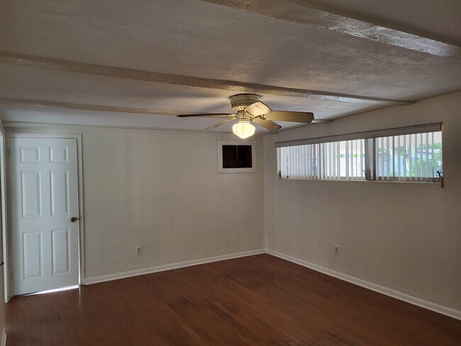Dining Family Room with ceiling fan and door leading into utility room. - 4425 Bradley Ave