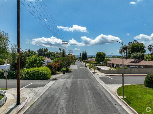 A tree-lined street in Northridge with large homes and wide streets.