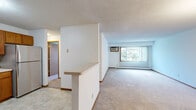 Located at 3415 Federal Dr in Eagan, MN, this two-bedroom, one-bathroom residence offers a functional and comfortable single-floor layout. The combined living and dining area is bright and spacious, featuring plush carpeting, a textured ceiling, a chandelier light fixture, and a large window with vertical blinds that fills the space with natural light and offers pleasant outdoor views. A wall-mounted AC unit and baseboard heating provide year-round climate control.

The kitchen is well-appointed with warm oak cabinetry offering ample upper and lower storage, light countertops, tile-style flooring, and a full suite of stainless steel appliances including a refrigerator, electric range with overhead exhaust, and dishwasher.

The primary bedroom is generously sized, featuring large dual sliding-door closets, carpet flooring, a window with outdoor views, and its own wall-mounted AC unit. The second bedroom also offers carpeting, a sliding-door closet, and a bright window. Four closets throughout the unit ensure abundant storage.

The bathroom includes tile-style flooring, a vanity, toilet, and a bathtub with shower. Clean white walls and warm wood-toned accents carry throughout the home, creating a cohesive and practical living environment.