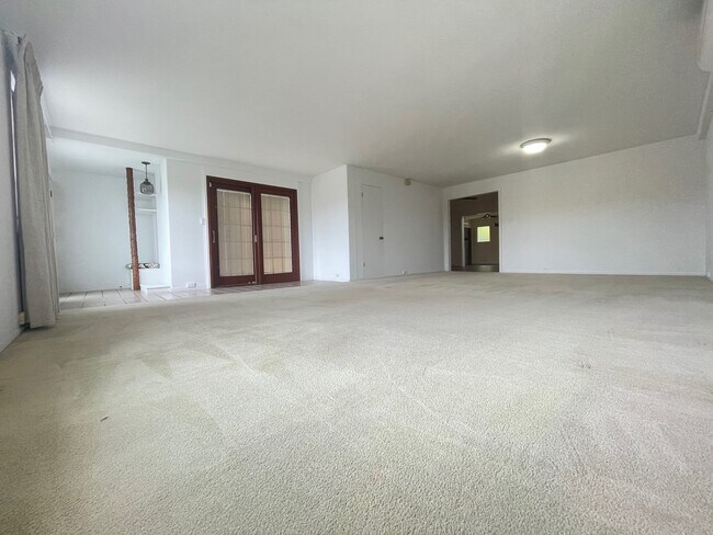 Living room facing entry, side patio, closet and kitchen - 45-560 Kiani St