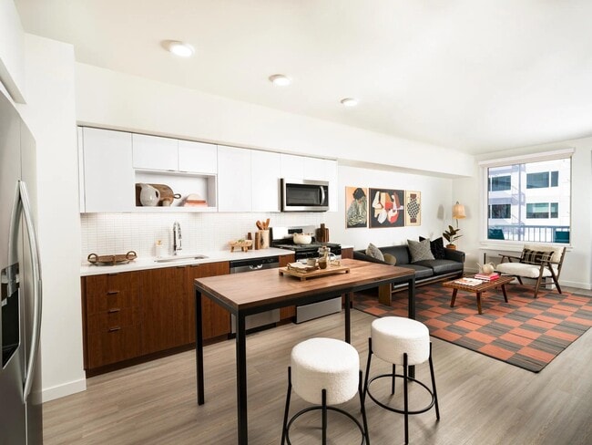 Chef-inspired kitchens featuring quartz countertops, designer cabinetry, and sleek under-cabinet lighting. - Modera Raleigh Hills