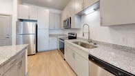Located at 609 Doral Pointe in Mount Juliet, Tennessee, this single-floor residence offers a clean, modern aesthetic with thoughtfully designed interiors throughout. The kitchen is a standout feature, showcasing granite countertops, white subway tile backsplash, gray shaker-style cabinetry, and a full suite of stainless steel appliances including a refrigerator, electric range, microwave, and dishwasher. A deep stainless steel sink with a flexible pull-down faucet adds both style and function, while light wood-tone flooring ties the space together seamlessly.

The living area is bright and open, with light wood-tone flooring continuing from the kitchen, a ceiling fan, and a large window that invites natural light and outdoor views. The bedrooms feature soft, neutral carpeting, ceiling fans, and windows with blinds that provide comfortable privacy. One bedroom also includes access to a walk-in closet, adding practical storage.

The bathroom is finished with granite countertops, gray cabinetry, a large framed mirror, and wood-tone flooring, maintaining the cohesive modern palette found throughout the residence. Accessibility features such as grab bars are also present. Overall, the space presents a bright, neutral, and well-appointed living environment in a desirable Mount Juliet location.