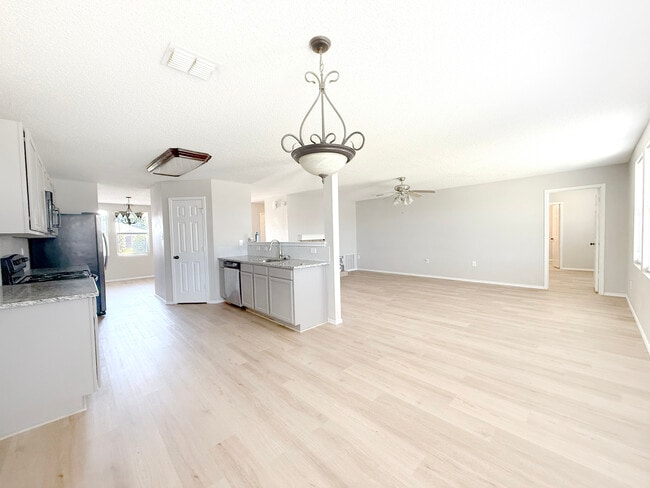 Eat-in looking through to formal dining and living. - 1419 Windy Meadows Dr