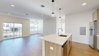 Located at 9 Monticello Dr in Brewster, NY, this thoughtfully designed 2-bedroom, 3-bathroom residence offers a clean, modern aesthetic with high-quality finishes throughout its well-appointed single floor. Light-toned hardwood flooring flows seamlessly across every room, creating a cohesive and airy atmosphere.

The open-concept kitchen and living area serves as the heart of the home. The kitchen features a large central island with a white quartz countertop, an undermount sink, and warm natural wood cabinetry accented with gold-toned hardware. Stainless steel appliances, including a range, over-the-range microwave, and refrigerator, are complemented by a classic white subway tile backsplash. Stylish globe pendant lights hang above the island, adding a contemporary touch. The adjacent living area is bright and welcoming, benefiting from large sliding glass doors and multiple windows that invite abundant natural light.

The primary bedroom is generously proportioned, bathed in natural light, and includes access to a dedicated walk-in closet with built-in wire shelving. The second bedroom also features large windows with views of the surrounding neighborhood. All three bathrooms are finished with light wood vanities, white quartz countertops, framed mirrors, and tile accents, maintaining a consistent modern style throughout the home.