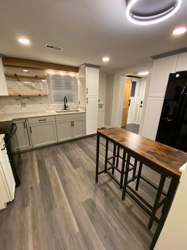 Modern kitchen with bar seating area - 1603 Washington St E