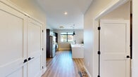Located at 924 Farmington Ave in West Hartford, CT, this well-appointed 2-bedroom, 2-bathroom residence offers a thoughtfully designed single-floor layout with modern finishes throughout. The open-concept kitchen and living area serves as the heart of the home, featuring dark shaker-style cabinetry with gold hardware, sleek white countertops, stainless steel appliances, and stylish pendant lighting. Large black-framed windows flood both the kitchen and living area with natural light and offer pleasant outdoor views of the surrounding neighborhood. Light-toned hardwood flooring flows seamlessly throughout the main living spaces, adding warmth and continuity. The living area provides a comfortable and inviting atmosphere with recessed lighting and ample room to relax. Both bedrooms are well-sized and carpeted, with large windows that bring in natural light and treetop views. The primary bedroom includes generous closet space. The two bathrooms are finished with large-format tile flooring, dark vanity cabinetry, white countertops, and elegant marble-style wall tile, delivering a spa-like aesthetic. With five closets and an in-unit laundry, this residence balances style with practical everyday functionality.