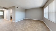 Located at 1699 68th St N in Saint Petersburg, FL, this one-bedroom, one-bathroom unit offers a well-designed single-floor layout that maximizes every square foot. Throughout the space, light-toned luxury vinyl plank flooring and neutral gray walls create a clean, cohesive aesthetic, while textured ceilings add a classic Florida touch.

The living room is a comfortable, open area filled with natural light from a large window fitted with vertical blinds, offering a pleasant outdoor view of surrounding greenery. The space flows naturally into the rest of the unit, creating an easy sense of connectivity.

The kitchen is a standout feature, equipped with stainless steel appliances including a refrigerator, range, and dishwasher. White cabinetry with brushed nickel hardware pairs elegantly with granite countertops. A stainless steel sink and a full-size in-unit washer are also integrated into this functional space.

The bedroom is generously proportioned, featuring the same warm flooring and a large window that invites natural light and outdoor views. The bathroom is finished with granite countertops, white cabinetry, and a framed mirror, maintaining the refined design language found throughout the unit. This space combines practical functionality with modern finishes in a desirable Saint Petersburg location.