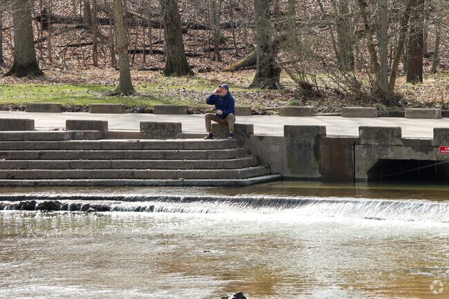 A man takes a break, creekside, at the Big Creek Reservation, in Parma Heights.