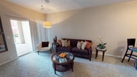 Located at 1511 Westpark View Dr in Fort Worth, TX, this single-story residence offers a well-planned layout with distinct living spaces designed for comfort and functionality. The living room is a welcoming focal point, featuring vaulted ceilings, soft carpeting, a ceiling fan, and a sliding glass door that allows natural light to fill the space. A wood-burning fireplace anchors the main living area, adding warmth and character. Adjacent to the living room is a dedicated dining area, intimate in scale and defined by its cozy corner placement. The galley-style kitchen is efficiently designed with cabinetry on both sides, laminate countertops, white appliances including a range, refrigerator, microwave, and dishwasher, and durable wood-look flooring that adds a modern touch. The bedroom is a comfortable retreat with plush carpeting, a ceiling fan, a large window with natural light, and a generous sliding-door closet offering ample storage. The bathroom features a wide vanity with extended countertop space, dark wood-look flooring, and a walk-in shower area. Throughout the residence, a neutral color palette and consistent finishes create a cohesive and inviting atmosphere.