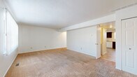 Located at 1580 Prospect Street in Elyria, Ohio, this two-story home offers three bedrooms and two bathrooms across a well-organized floor plan. The main level hosts two living areas, a kitchen, and connecting hallways, while the upper level accommodates the bedrooms and additional living space. Throughout the home, neutral-toned carpeting provides a warm and consistent feel.

The kitchen is appointed with rich, dark cabinetry offering generous storage, light-toned countertops, a dishwasher, gas range, and refrigerator. Stone-look tile flooring grounds the space, and a window above the sink allows for natural light.

The living areas are open and airy, with clean white walls and a sliding glass door in one room that fills the space with natural light and provides outdoor access. Six-panel interior doors and textured ceilings are consistent design elements throughout.

The generously sized primary bedroom features a ceiling fan with lighting, a window for natural light, and a large closet with bifold doors and a clothing rod. The additional bedrooms are well-proportioned and carpeted.

The bathroom includes a tiled tub-shower combination, wainscoting, stone-look tile flooring, and a window that brings in natural light. Hallways connect each level efficiently, and a staircase links the two floors seamlessly.